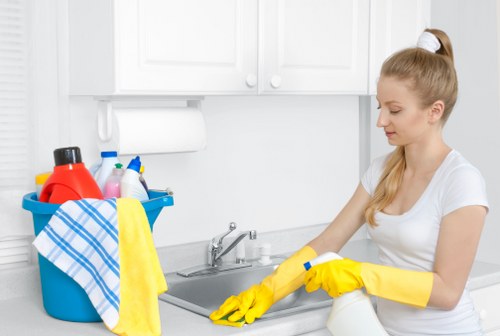Cleaner wearing PPE while treating a carpet in Belgravia